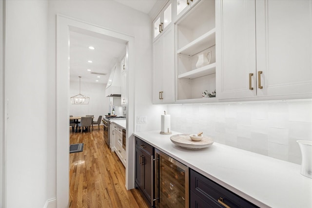 319 E 26th St, Houston, TX 77008 - bar area with beverage cooler, light wood-type flooring, backsplash, high end range, and custom exhaust hood
