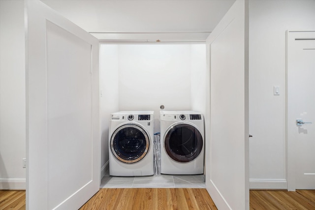319 E 26th St, Houston, TX 77008 - laundry area with washer and dryer and wood finished floors