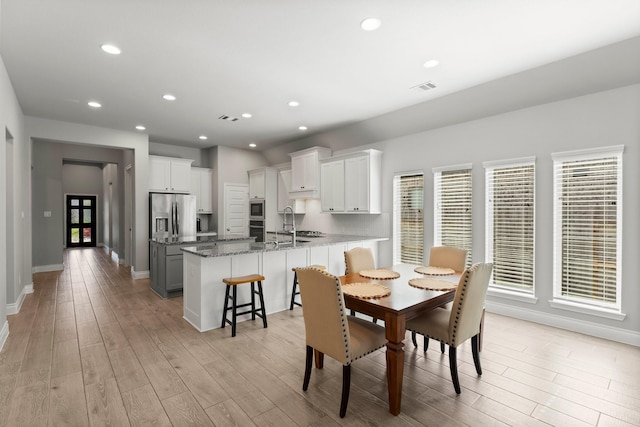19419 Filly Chase Ct, Tomball, TX 77377 - dining space with light wood-style flooring, recessed lighting, and baseboards