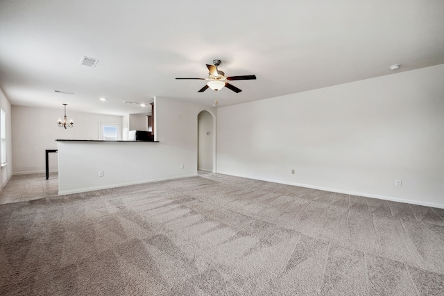 6023 Treasure Cove Rd, Cove, TX 77523 - unfurnished living room featuring a chandelier, light carpet, a ceiling fan, and arched walkways