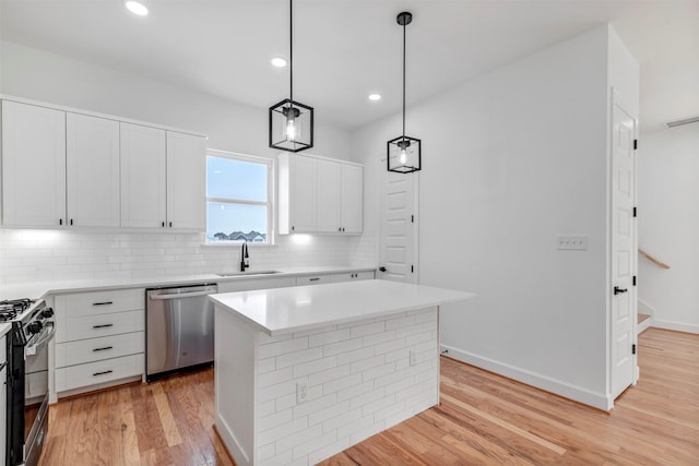 1232 E 23rd St, Houston, TX 77009 - kitchen with dishwasher, gas stove, a sink, tasteful backsplash, and light wood finished floors