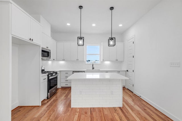 1232 E 23rd St, Houston, TX 77009 - kitchen with stainless steel appliances, a sink, light countertops, tasteful backsplash, and light wood-type flooring