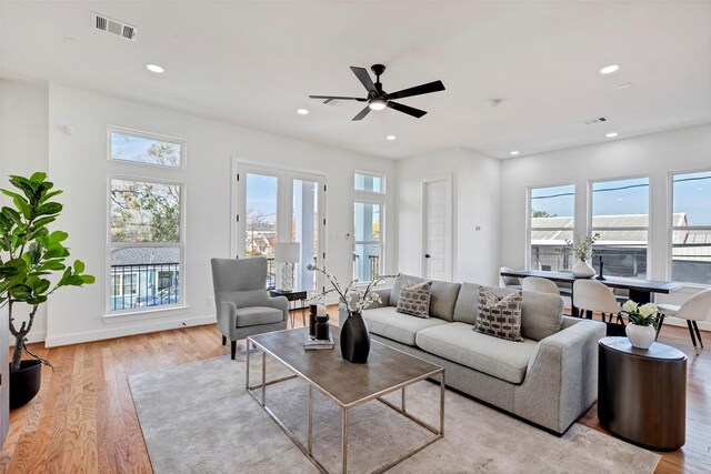 1232 E 23rd St, Houston, TX 77009 - living room featuring healthy amount of natural light, recessed lighting, light wood finished floors, a ceiling fan, and baseboards