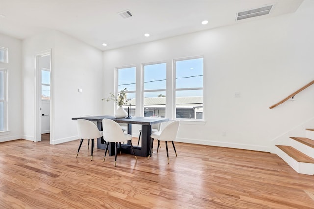 dining space with light wood finished floors, stairs, baseboards, and recessed lighting