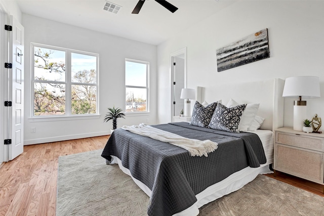 bedroom featuring light wood-style floors, baseboards, and a ceiling fan