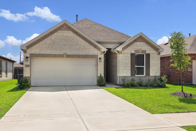 french country home with stone siding, driveway, a garage, a front lawn, and a shingled roof