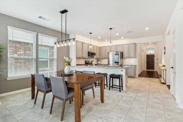 dining space featuring recessed lighting, baseboards, and light tile patterned floors