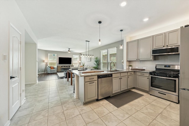 kitchen featuring appliances with stainless steel finishes, gray cabinetry, a ceiling fan, tasteful backsplash, and recessed lighting