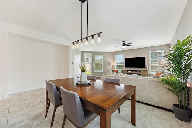 dining room featuring ceiling fan, light tile patterned floors, and baseboards