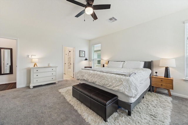 carpeted bedroom with baseboards, ensuite bathroom, and a ceiling fan