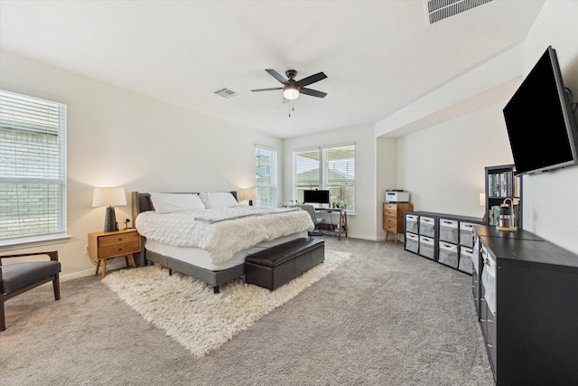 bedroom with light carpet, baseboards, ceiling fan, and a desk