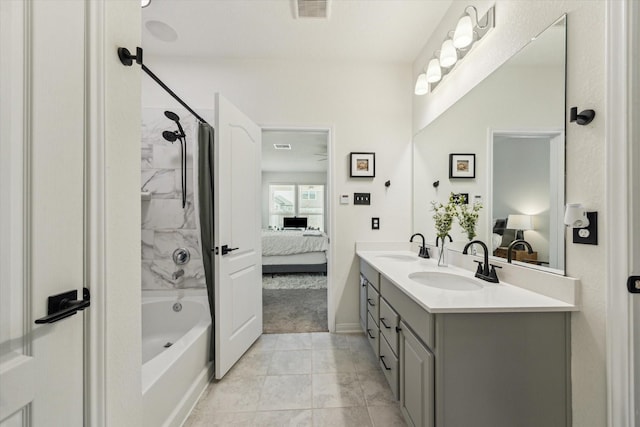 ensuite bathroom featuring double vanity, shower / tub combination, marble look tile flooring, and baseboards