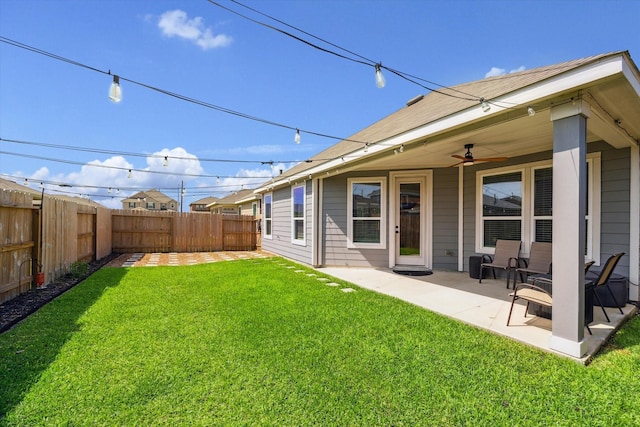 view of yard with ceiling fan and a patio