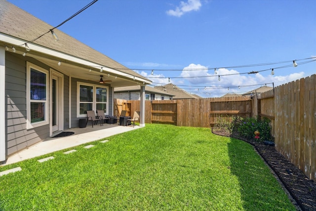 view of yard with a ceiling fan and a patio area