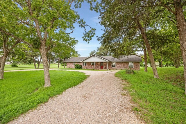 13016 W Burton St, Burton, TX 77835 - single story home with driveway, a front yard, and brick siding