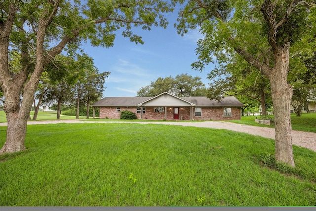 13016 W Burton St, Burton, TX 77835 - ranch-style home with a front yard, brick siding, and driveway