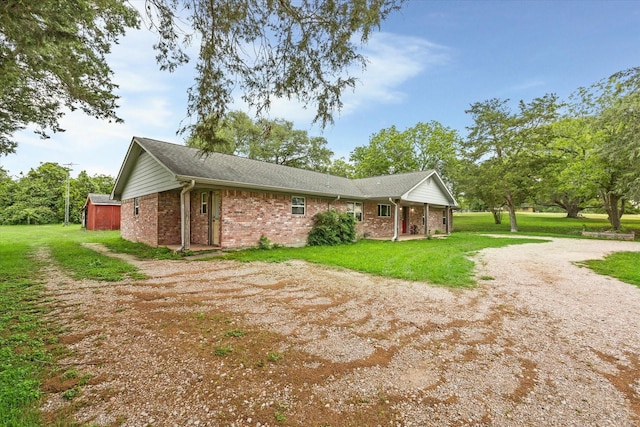 13016 W Burton St, Burton, TX 77835 - view of side of property with brick siding and a lawn