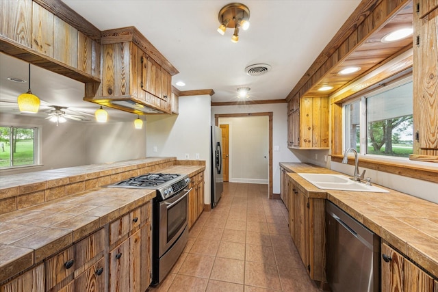 13016 W Burton St, Burton, TX 77835 - kitchen with appliances with stainless steel finishes, a sink, baseboards, light tile patterned floors, and a ceiling fan