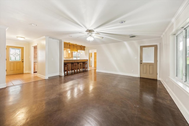 13016 W Burton St, Burton, TX 77835 - unfurnished living room with ornamental molding, plenty of natural light, a ceiling fan, baseboards, and concrete floors