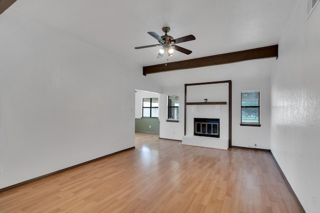 132 Prairie View Ln, Red Oak, TX 75154 - unfurnished living room featuring beamed ceiling, light wood-type flooring, a ceiling fan, a fireplace, and baseboards