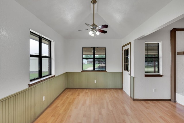 132 Prairie View Ln, Red Oak, TX 75154 - empty room featuring wood finished floors, wainscoting, a ceiling fan, and vaulted ceiling