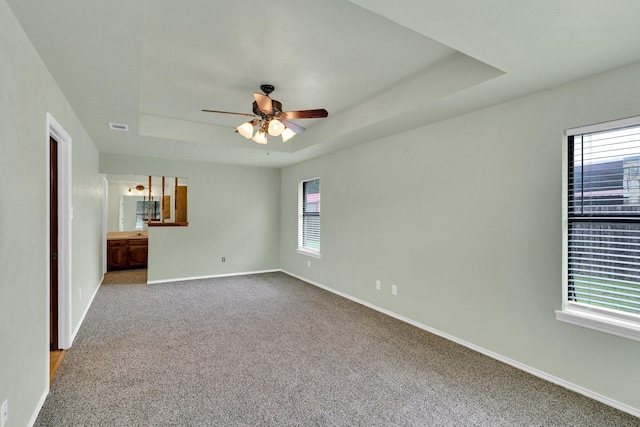132 Prairie View Ln, Red Oak, TX 75154 - unfurnished room featuring a tray ceiling, healthy amount of natural light, carpet floors, and baseboards
