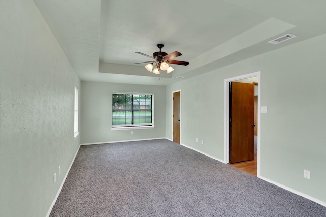 132 Prairie View Ln, Red Oak, TX 75154 - spare room with carpet, a ceiling fan, baseboards, and a tray ceiling