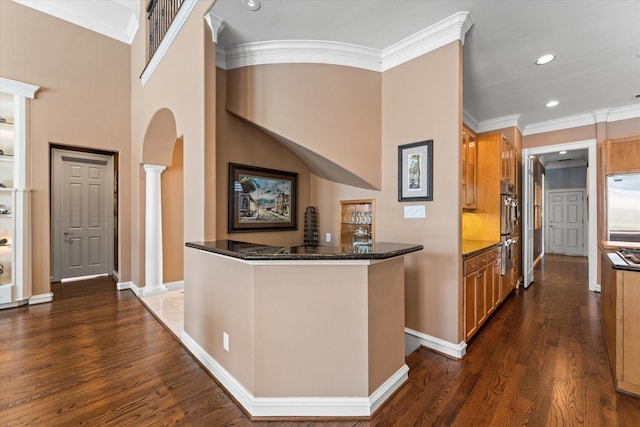 5206 Stamper Way, Houston, TX 77056 - corridor featuring arched walkways, decorative columns, crown molding, dark wood-style floors, and baseboards
