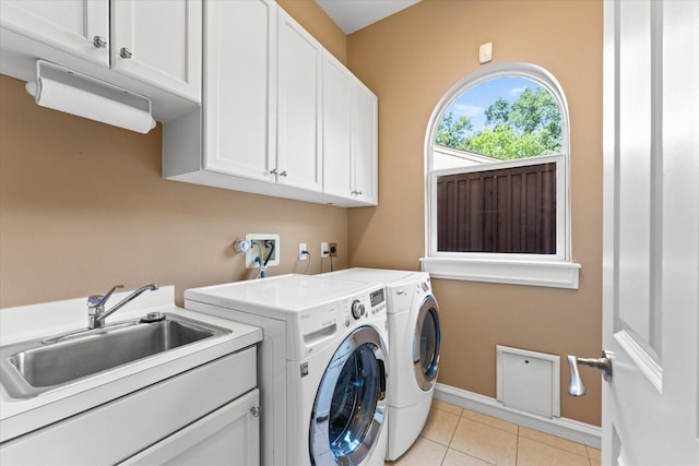 5206 Stamper Way, Houston, TX 77056 - laundry area featuring cabinet space, washing machine and clothes dryer, baseboards, and light tile patterned flooring