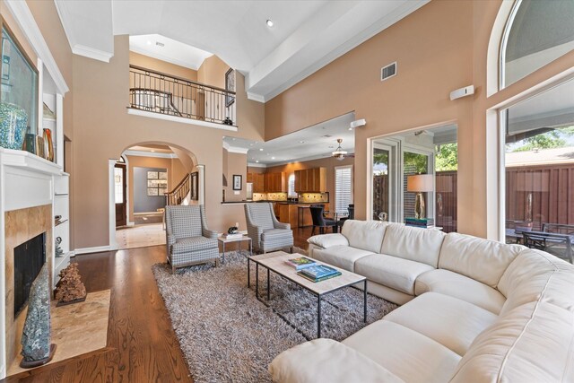 5206 Stamper Way, Houston, TX 77056 - living area with arched walkways, wood finished floors, a high ceiling, baseboards, and a premium fireplace