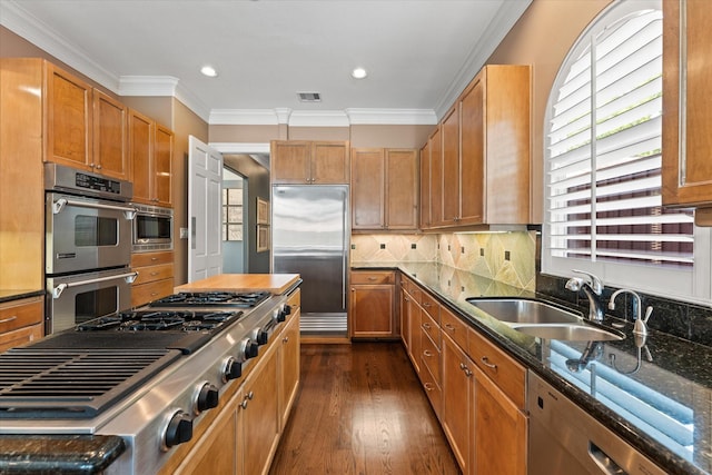 5206 Stamper Way, Houston, TX 77056 - kitchen with built in appliances, dark stone counters, a sink, dark wood-style flooring, and ornamental molding