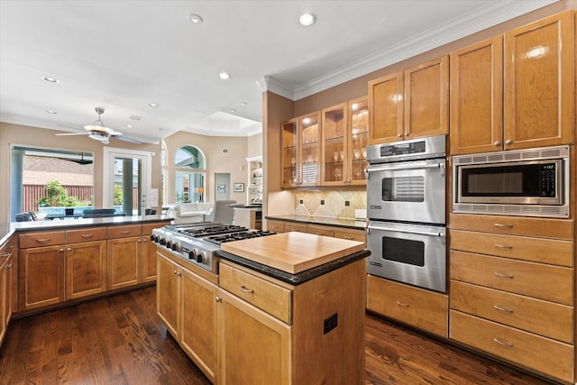 5206 Stamper Way, Houston, TX 77056 - kitchen featuring appliances with stainless steel finishes, a center island, recessed lighting, tasteful backsplash, and dark wood-type flooring