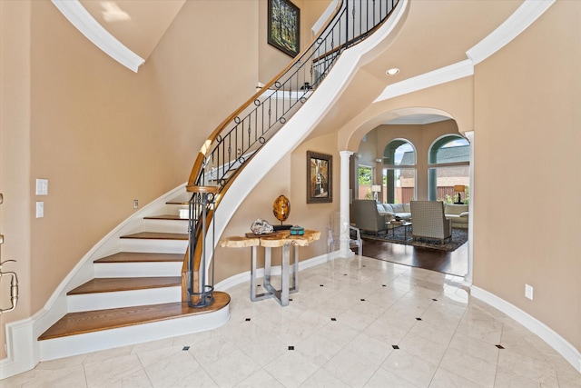 5206 Stamper Way, Houston, TX 77056 - foyer featuring a towering ceiling, baseboards, arched walkways, stairway, and crown molding