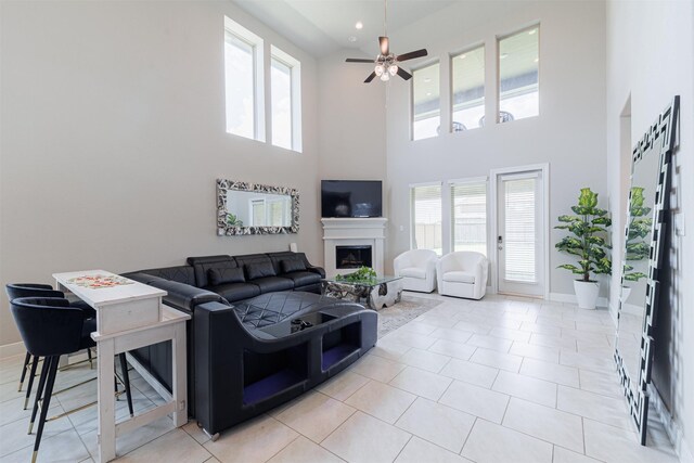 3514 Hampton Landing Ct, Katy, TX 77494 - living room with a high ceiling, healthy amount of natural light, a fireplace, a ceiling fan, and light tile patterned floors