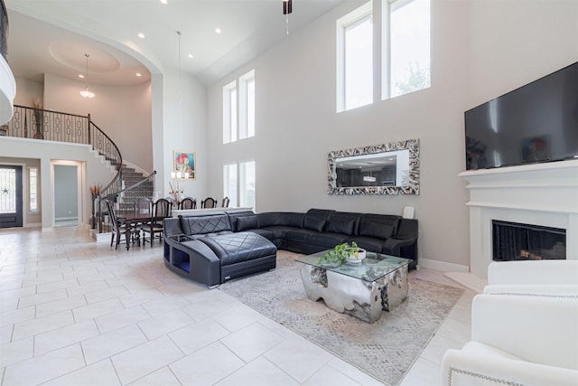 3514 Hampton Landing Ct, Katy, TX 77494 - tiled living area with a towering ceiling, stairway, healthy amount of natural light, a fireplace with raised hearth, and recessed lighting