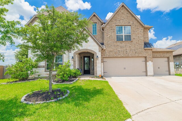 3514 Hampton Landing Ct, Katy, TX 77494 - view of front of house featuring brick siding, concrete driveway, a front yard, an attached garage, and stone siding