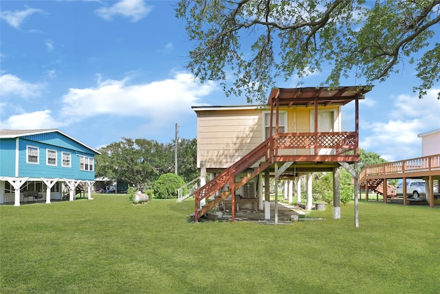 116 Linda St, Anahuac, TX 77514 - view of green lawn featuring stairway and a deck