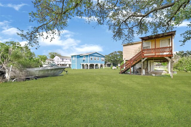116 Linda St, Anahuac, TX 77514 - view of grassy yard featuring stairs and a wooden deck