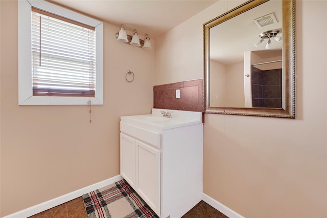 116 Linda St, Anahuac, TX 77514 - bathroom featuring baseboards and vanity