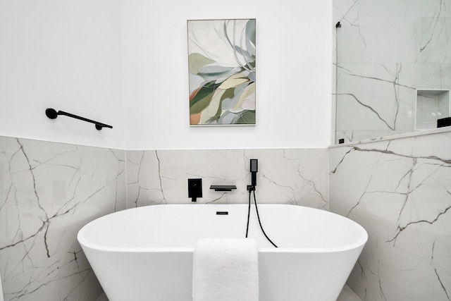 5520 Chapman St, Houston, TX 77009 - bathroom featuring tile walls and a soaking tub