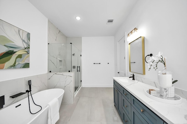 5520 Chapman St, Houston, TX 77009 - full bath with a marble finish shower, a freestanding tub, double vanity, and recessed lighting