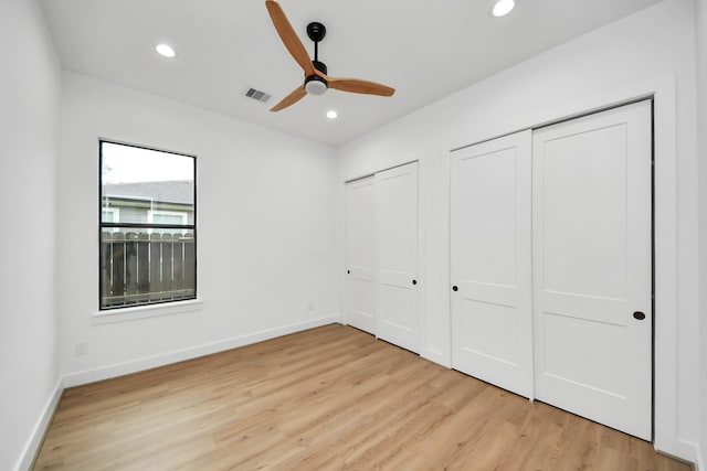 5520 Chapman St, Houston, TX 77009 - unfurnished bedroom featuring multiple closets, light wood-type flooring, recessed lighting, and baseboards