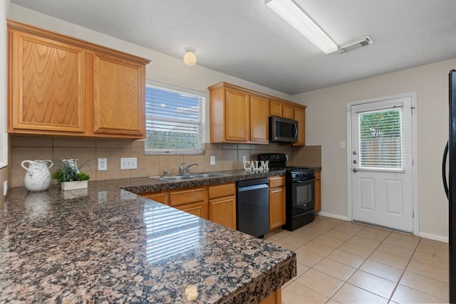 14502 Windmill Meadows Ct, Houston, TX 77082 - kitchen featuring dishwasher, black range with gas stovetop, stainless steel microwave, a sink, and decorative backsplash