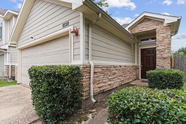 14502 Windmill Meadows Ct, Houston, TX 77082 - property entrance featuring stone siding and an attached garage