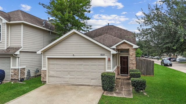 14502 Windmill Meadows Ct, Houston, TX 77082 - view of front of home featuring concrete driveway, stone siding, a front lawn, roof with shingles, and a garage
