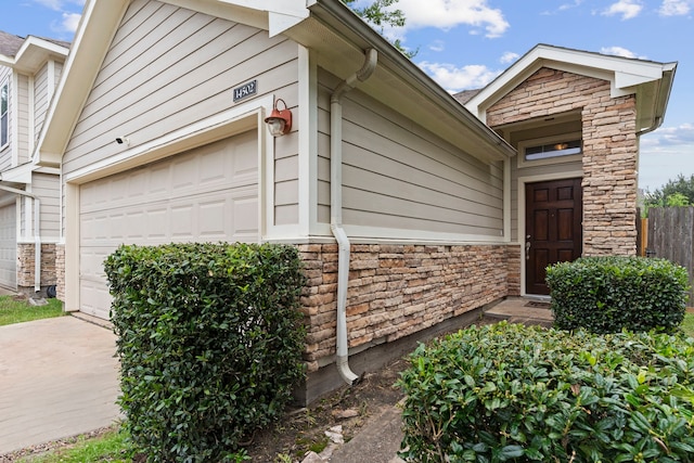 14502 Windmill Meadows Ct, Houston, TX 77082 - view of side of home with stone siding and driveway