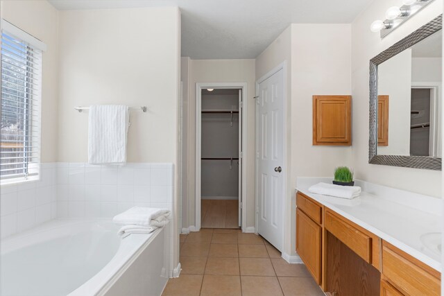14502 Windmill Meadows Ct, Houston, TX 77082 - bathroom featuring tile patterned floors, a bath, vanity, a walk in closet, and baseboards