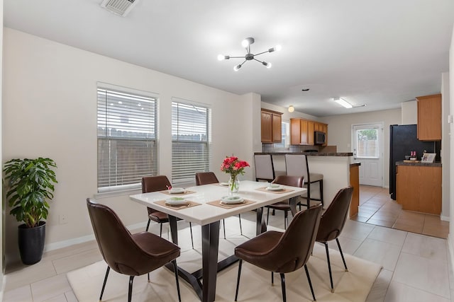 14502 Windmill Meadows Ct, Houston, TX 77082 - dining space with a chandelier, light tile patterned flooring, and baseboards