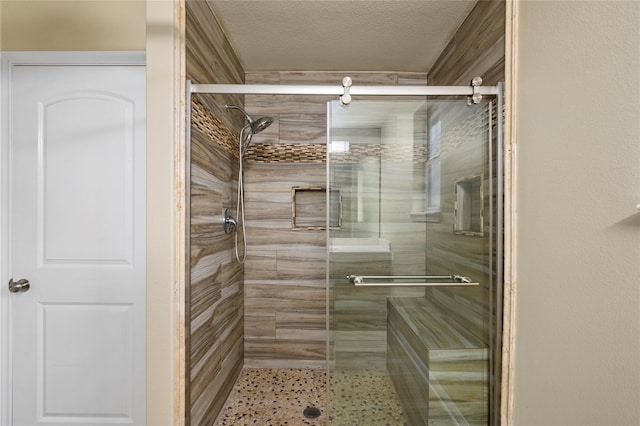 bathroom featuring a relaxing sauna, a stall shower, and a textured ceiling