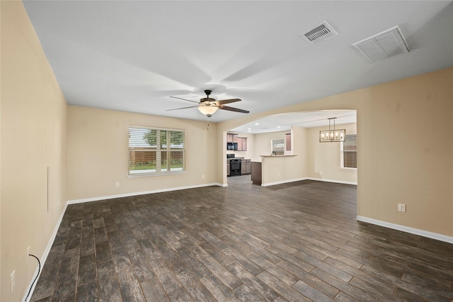 unfurnished living room featuring dark wood-style flooring, ceiling fan, and baseboards